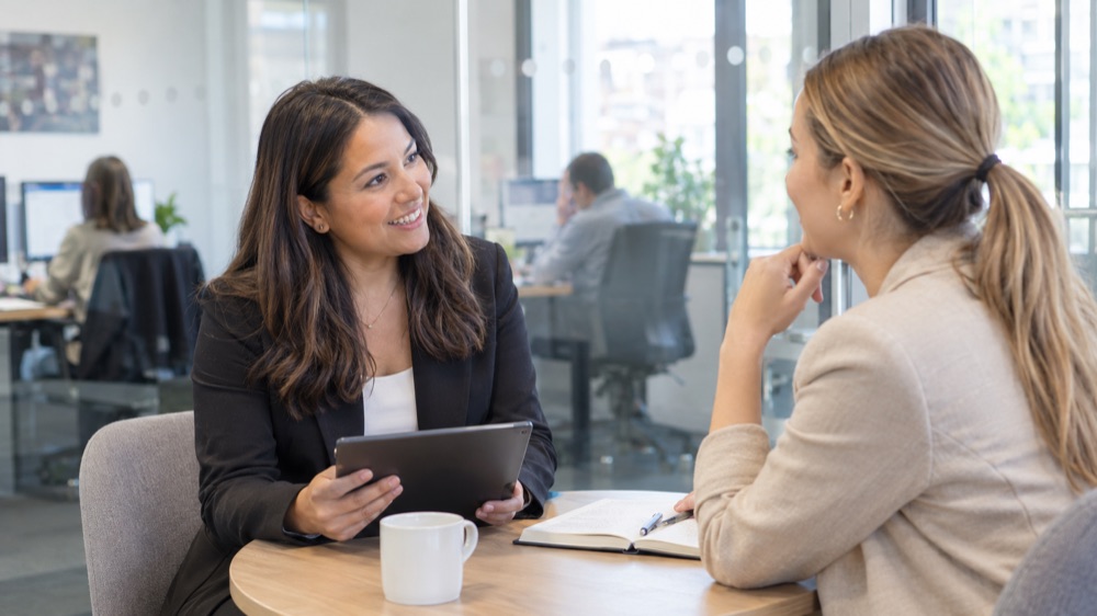 Recruitment consultant talking with a candidate in a bright meeting room